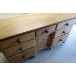 Victorian sideboard with central drawer above recessed cupboard door flanked by six further short