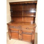 An old charm style oak dresser with 2 tier raised back above 2 drawers and 2 cupboard doors (122cm