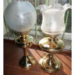 Two brass oil lamps with etched glass shades