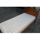 A pair of pine framed single bedsteads with mattresses