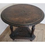Late Victorian oak occasional table, circular carved top with gadrooned edge, triform base with