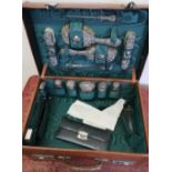 Tan leather travelling vanity case with green silk lined fitted interior, with various accessories