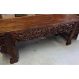 Chinese hardwood alter table with frieze drawers to each end, and elaborate carved panels to the