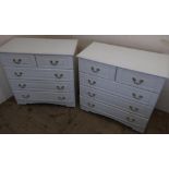 Pair of white laminate chest of drawers comprising of two short above three long drawers (83cm x