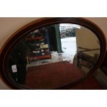 19th C oval mahogany and cross banded beveled edge wall mirror (67cm x 52cm)