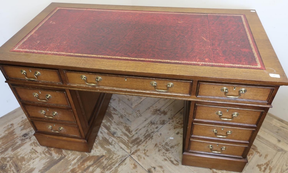 Modern oak Edwardian style twin pedestal desk with leather insert top, central drawer flanked by two