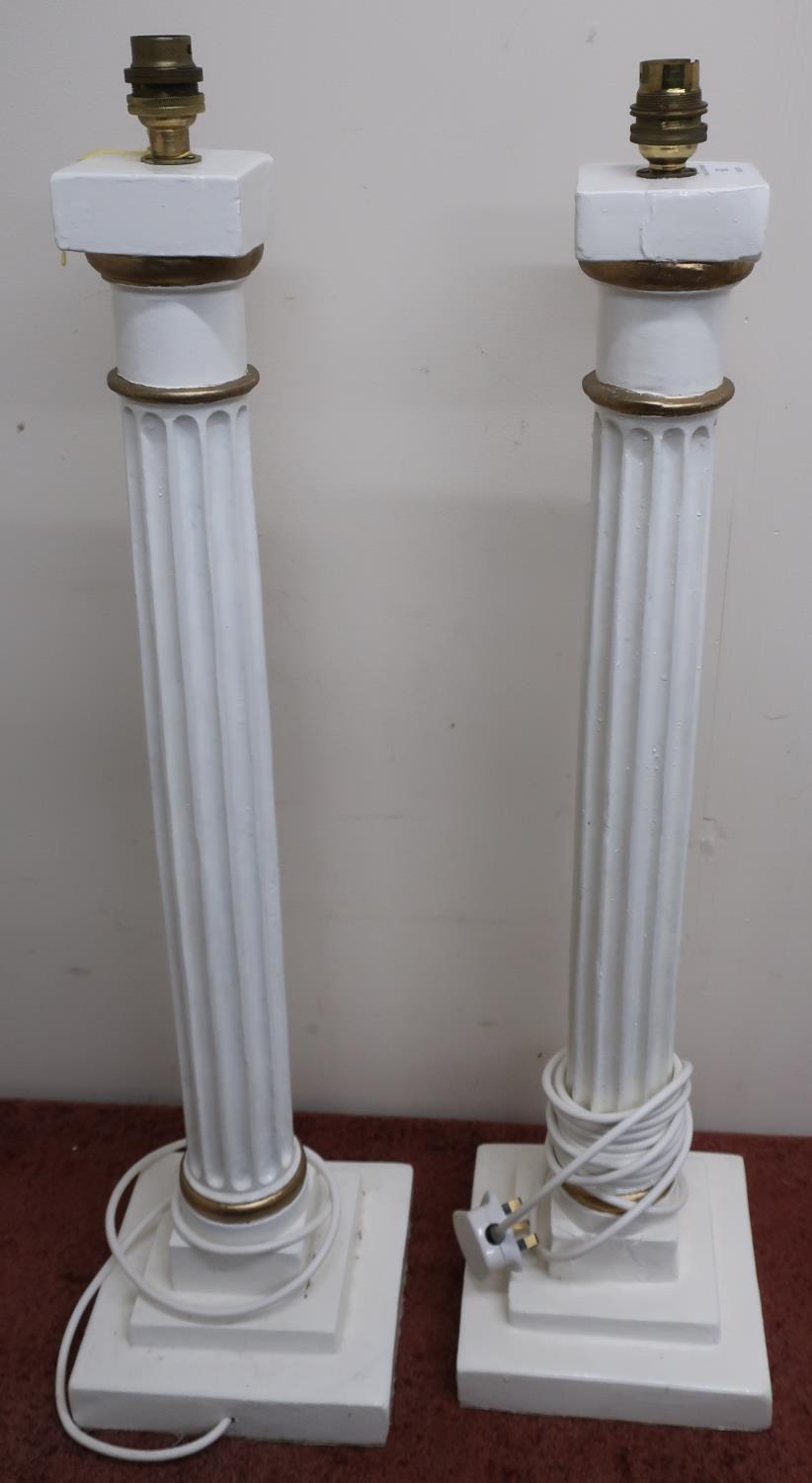 Large pair of white and gilt painted wooden Corinthian column table lamps on stepped square bases (