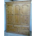 Large modern triple door pine wardrobe with three short and two long drawers to the base (154cm x