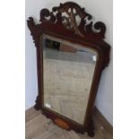 Regency style mahogany framed wall mirror with carved and inlaid detail with a gilt figure of a bird