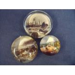 Set of three souvenir glass paperweights depicting Scarborough and Filey