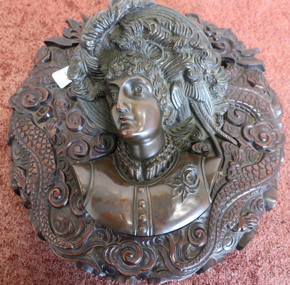 Unusual circular wall plaque with heavy carved hardwood frame in Oriental style depicting various