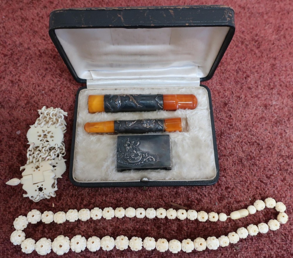 Early 20th C carved articulated ivory bracelet, a similar bead-work bracelet and a cased smoking set