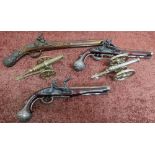 Pair of reproduction flintlock dueling pistols, another pistol, and two cannons