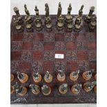 Carved wood and cast metal medieval style chess set in the form of knights, kings, queens etc.