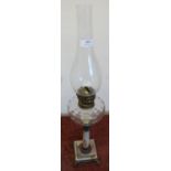 Oil lamp with molded clear glass reservoir on carynthum marble column and stepped square base (