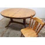 Modern pine oval extending dining table on twin column supports and a single chair