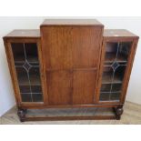 1920s combination oak side cabinet with fall front above two cupboard doors flanked by two lead