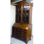 19th C mahogany bureau bookcase with arched top above two glazed cupboard doors with shelved