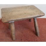19th C elm rectangular topped milking type stool on four supports (1 leg loose)