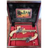 Cased pair of Spanish made reproduction flintlock pistols