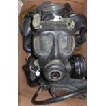 Box containing a large quantity of various British, Soviet and other gas masks, respirators,