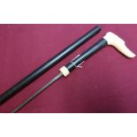 Early to mid 20th C ebonised sword cane with 22 1/2 inch blade marked Leon, and carved ivory dogs