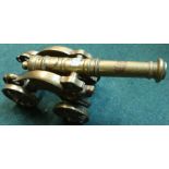 Heavy cast brass model of a cannon on four wheels, barrel length 15 inches
