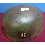 German steel para helmet with leather liner and painted SS decal, various stamp marks to the