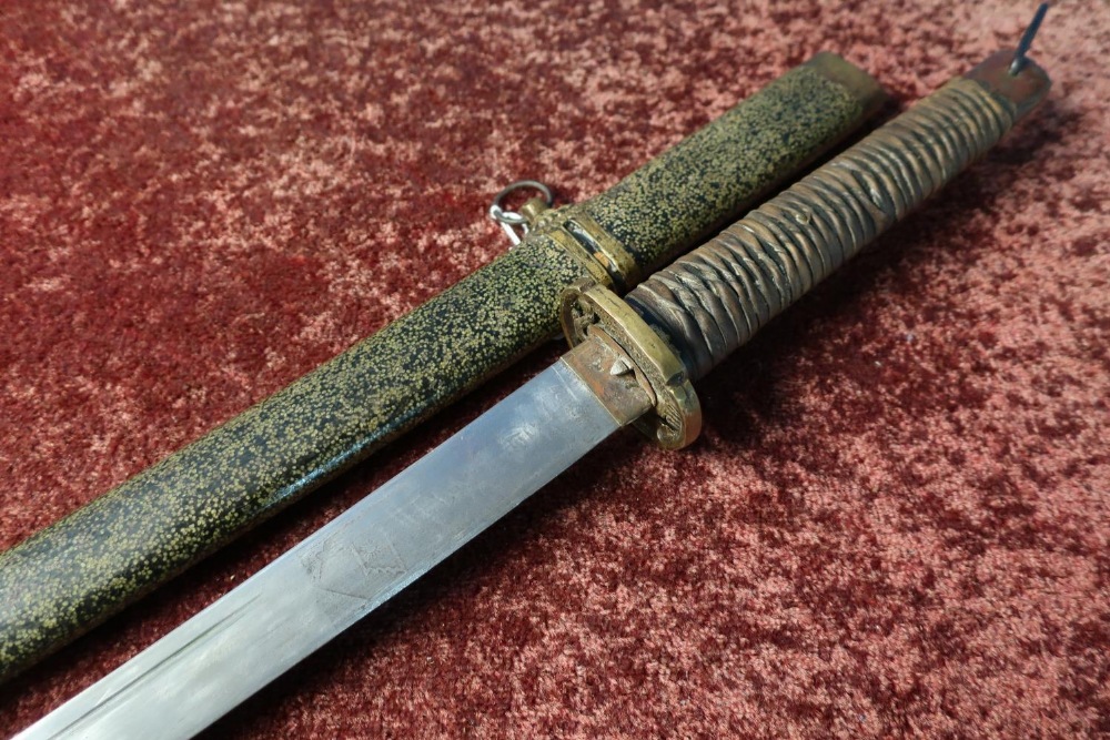 Japanese Samurai type sword with 28 1/2 inch slightly curved blade with traces of engraved detail,