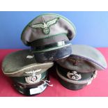 Three German military officers peaked caps, one with cloth eagle above swastika, two with metal