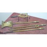 Art Nouveau brass three piece fire companion set and a brass trivet with turnwood handle