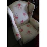 Victorian style wing back upholstered armchair on tapering supports