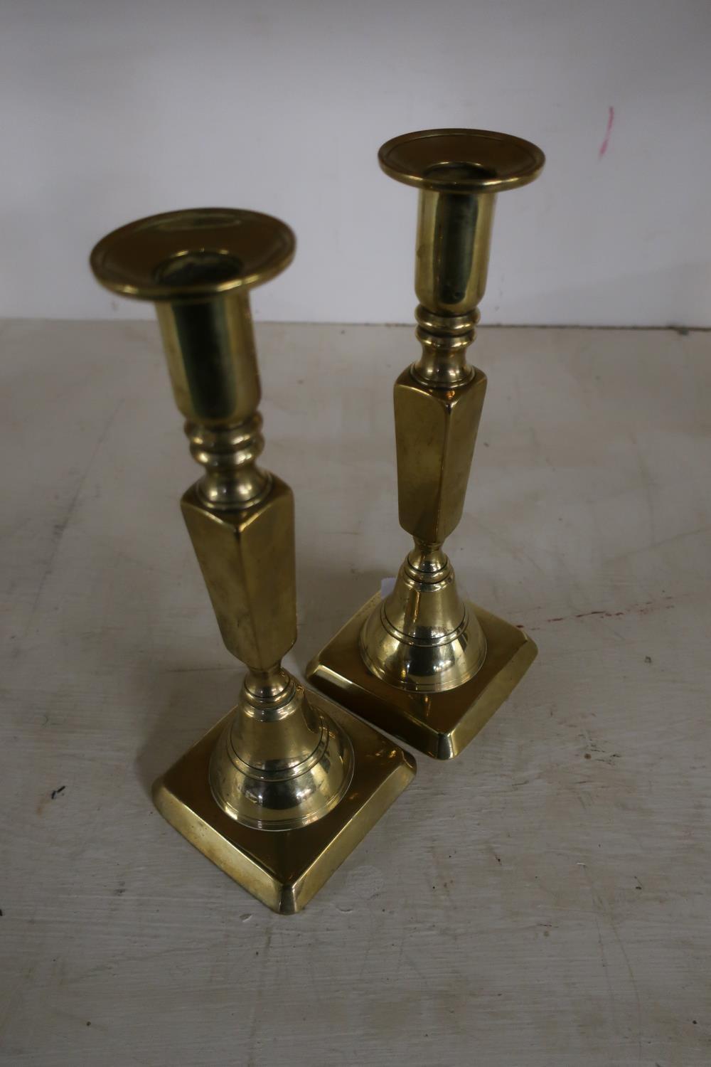 Pair of early 19th C brass candlesticks on square bases (height 25cm)