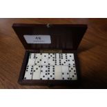 Early 20th C mahogany rectangular box containing a collection of carved bone dominoes (9.5cm x 6cm x