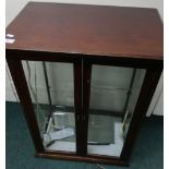 Edwardian mahogany counter top display cabinet with two glazed cupboard doors and milk glass base (