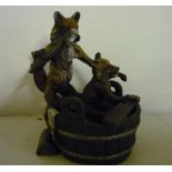 Cold painted bronze figure of a fox scrubbing a fox cub in a washtub (9.5cm high), the base