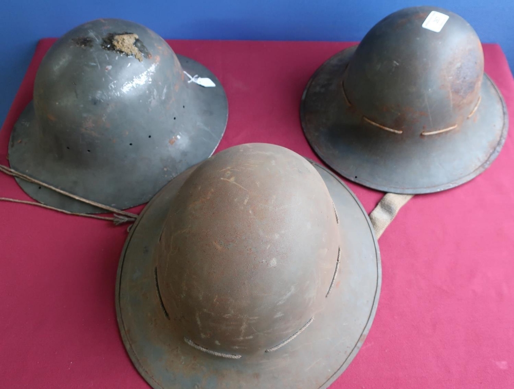 Three WWII British steel helmets, two complete with liners, one marked S.M.LD 1941 (3)