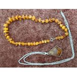 Hand tied strung amber necklace and a modern silver and amber pendant necklace (2)