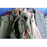 Quantity of British military clothing including shirts, raincoats, woolly pully, jumpers, thermal