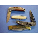 Group of four pocket knives with folding blades including one by Winchester