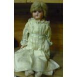 Armand Marseille porcelain headed doll with moving eyes and silk-work dress, the reverse of the neck