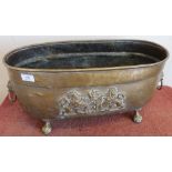 Brass oval planter with Belgium coat of arms crest to the front, ball and claw feet and lion mask