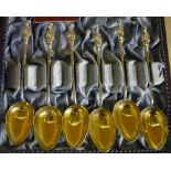 Cased set of six Wang Hing white metal teaspoons with gilt bowls and figure crested finials, with
