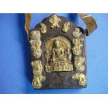 Far Eastern travelling brass icon panel comprising of leather strap and wooden plaque mounted with