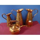 Large copper jug marked J.S & SB No 4, two similar jugs with crocodile skin effect pattern and a