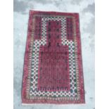 Traditional pattern red ground wool rug (80cm x 137cm)