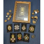 Selection of military embroidered cloth patches, various military buttons, belt clasps, a framed