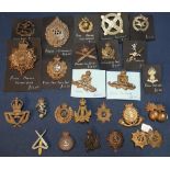 Selection of various military cap badges including Highland Regiment, Kings Own Malta Regiment,