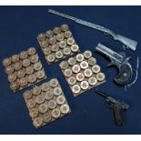 Four coasters with shotgun cartridge brass end tops, Derringer type pistol belt buckle, pewter