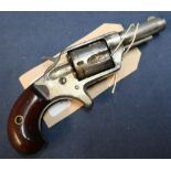 Colt .32 rimfire revolver with 2 1/4 inch barrel, engraved details to the top and two piece wooden